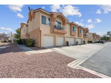 Charming two-story townhome featuring attached garages and private balconies in a well-maintained community at 5000 Red Rock St # 241, Las Vegas, NV 89118