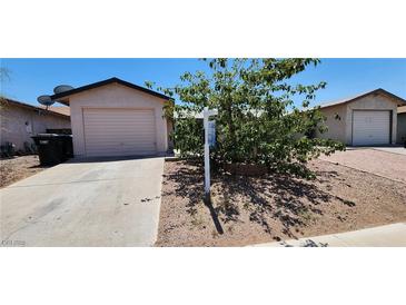 Charming single-story home featuring a private garage and a well-maintained front yard with mature landscaping at 510 Holick Ave, Henderson, NV 89011