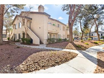 Charming multi-Gathering home featuring classic architecture and landscaped surroundings under a sunny sky at 5211 Caspian Springs Dr # 201, Las Vegas, NV 89120