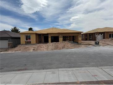 A new construction home featuring a light brown roof and framing, awaiting exterior finishes, promising a modern design at 579 Jerry Bird Ct, Las Vegas, NV 89123
