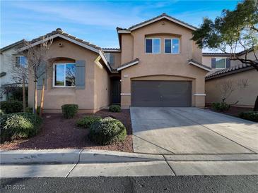 Inviting two-story home features a well-kept lawn and a two-car garage at 7371 Castano Vista Ct, Las Vegas, NV 89179