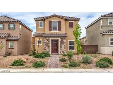 Two-story home with stone accents, desert landscaping, and a brick walkway at 1115 Brilliant Meadow Ave, North Las Vegas, NV 89086