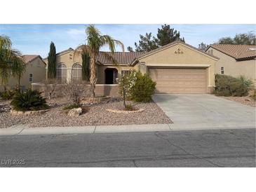 Charming single-story home with desert landscaping, a two-car garage and inviting curb appeal at 1654 Danbury Crossing Dr, Henderson, NV 89052