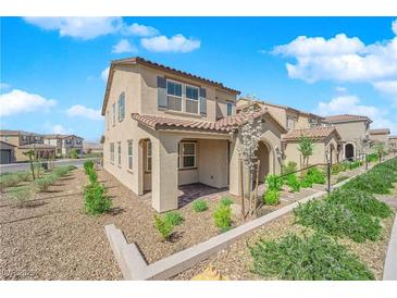 Charming two-story home featuring a stucco exterior, tile roof, and well-maintained landscaping in a sunny neighborhood at 2449 Padulle Pl, Henderson, NV 89044