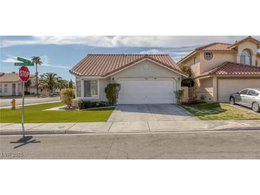 Charming single-story home featuring a well-manicured lawn, tile roof and a two-car garage at 301 Montcliff Ave, Henderson, NV 89074