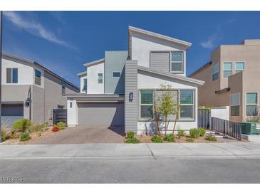 Modern two-story home with gray and white color scheme, landscaped front yard, and attached two-car garage at 3264 Monte Luna Ave, Henderson, NV 89044