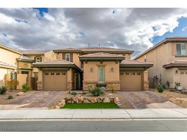 Charming home featuring a private courtyard entrance, two-car garages, and tasteful desert landscaping at 3829 Hawkeye Falls Ave, North Las Vegas, NV 89085