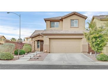 Two-story home featuring a large garage, desert landscaping and attractive stone accents at 4224 Galapagos Ave, North Las Vegas, NV 89084