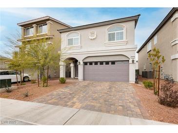 Charming two-story home featuring an attached two-car garage and a beautifully landscaped front yard at 5384 Knitmore Ct, Las Vegas, NV 89139