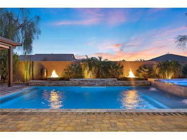 Backyard pool featuring fire bowls, and water feature at 5523 Taylor Rose Ave, Las Vegas, NV 89139