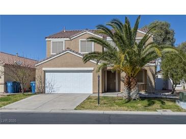 Charming two-story home with a two-car garage, palm tree, and well-maintained front yard at 5854 Heather Marie Dr, Las Vegas, NV 89110