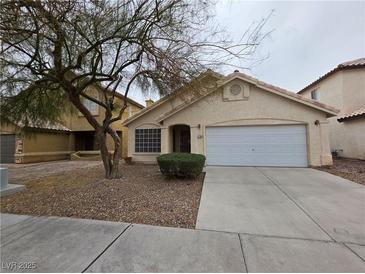 Charming single-story home with a two-car garage and well-maintained landscaping in a suburban neighborhood at 7209 London Bridge Ave, Las Vegas, NV 89130