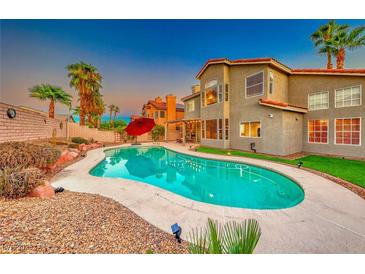 Inviting backyard pool with a charming home exterior and lush landscaping at 8240 Campana Dr, Las Vegas, NV 89147