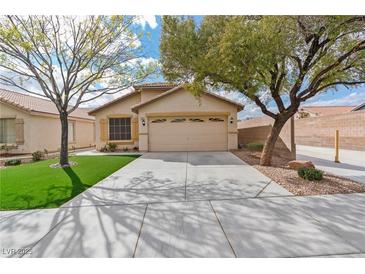 Charming single-story home featuring a two-car garage, xeriscaped yard, and mature shade trees enhancing its curb appeal at 11007 Vallerosa St, Las Vegas, NV 89141