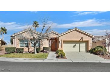 Charming single-story home with well-maintained landscaping and an attached two-car garage at 1112 Bower Basin St, Las Vegas, NV 89144