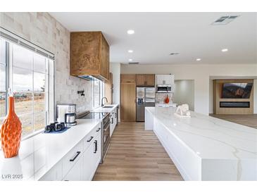 Bright kitchen featuring white cabinets, stainless steel appliances, and a large center island with Quartz countertops at 1891 Brian Rd, Pahrump, NV 89048