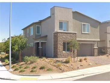 Charming two-story home featuring desert landscaping and stone accents on the facade and garage at 290 Mount Williamson St, Henderson, NV 89015