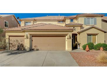 Charming two-story home featuring a three-car garage and well-maintained landscaping at 317 Shimmering Moon St, Henderson, NV 89015