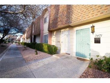 Inviting townhome featuring a tidy front yard, private entrance, and charming exterior details at 3467 Garden East Dr, Las Vegas, NV 89121