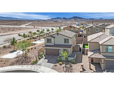 Inviting two-story home featuring desert landscaping and a neutral color scheme at 389 Scarlet Pine Ct, Henderson, NV 89044
