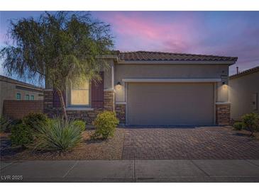 Charming single-story home with a brick driveway and well-maintained landscaping at 4708 Mindful St, North Las Vegas, NV 89031