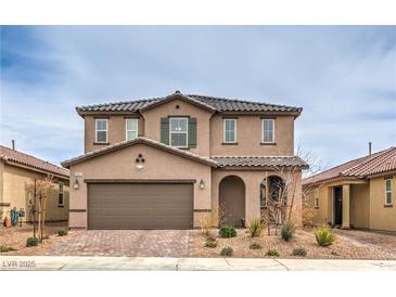 Inviting two-story home with a well-maintained front yard, covered entry, and an attached two-car garage at 6904 Baylor Creek St, North Las Vegas, NV 89086