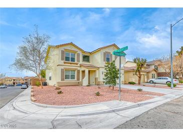 Charming two-story home with neutral stucco, tile roof and tidy desert landscaping in a suburban neighborhood at 9629 Grouse Grove Ave, Las Vegas, NV 89148