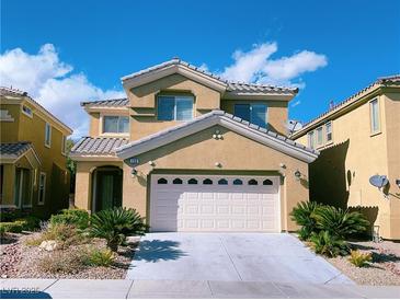 Charming two-story home with a well-manicured lawn and a two-car garage under a sunny sky at 150 Short Ruff Way, Las Vegas, NV 89148