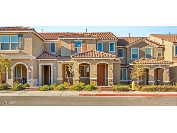 Charming townhome featuring a tiled roof, neutral stucco, and well-maintained landscaping in a cozy neighborhood at 2409 Bellinzona Pl, Henderson, NV 89044