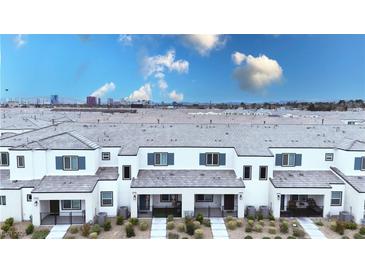 Charming townhomes with modern design, gray roofs, blue shutters, and inviting front patios at 3542 Arcadian King Ave, Las Vegas, NV 89106