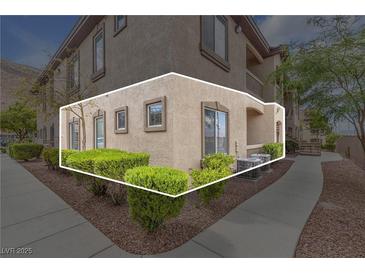 Condo exterior with manicured landscaping, walkway and neutral-toned stucco at 3544 Desert Cliff St # 102, Las Vegas, NV 89129