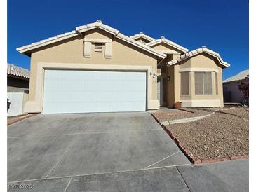 Inviting single-story home featuring a wide two-car garage and desert landscaping at 3836 Quail Creek Dr, North Las Vegas, NV 89032