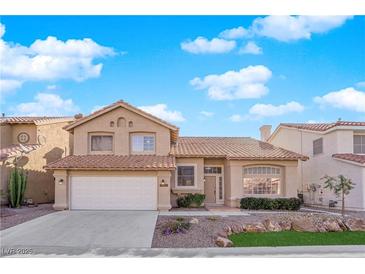 Charming two-story home featuring a tile roof, desert landscaping, and an attached two-car garage at 5000 Forest Oaks Dr, Las Vegas, NV 89149