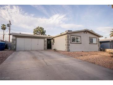 Single-story home featuring an attached garage and desert landscaping at 5408 Longridge Ave, Las Vegas, NV 89146