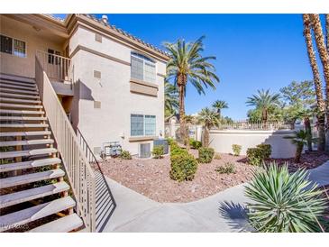 Well-maintained two-story exterior with landscaped grounds and staircase access at 7400 W Flamingo Rd # 1087, Las Vegas, NV 89147