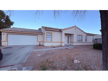 Inviting single-story home with a two-car garage and low-maintenance desert landscaping at 7904 Limbwood Ct, Las Vegas, NV 89131