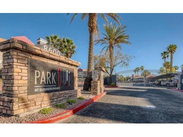 Community entrance sign, palm trees, and decorative gates at Park at Summerlingate at 8600 W Charleston Blvd # 1075, Las Vegas, NV 89117