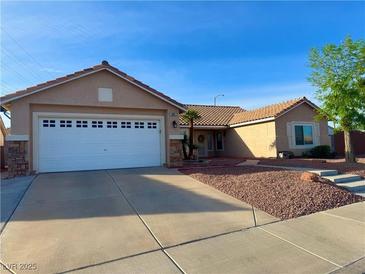 Charming single-story home featuring a two-car garage and low-maintenance landscaping at 1405 Bugle Boy Dr, Henderson, NV 89014