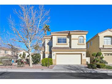 Charming two-story home featuring a well-manicured front yard and a classic tile roof at 1712 Warrenville St, Las Vegas, NV 89117