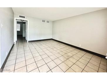 Spacious living room featuring neutral walls, tiled flooring, and ample natural light at 520 S 13Th St # D17, Las Vegas, NV 89101