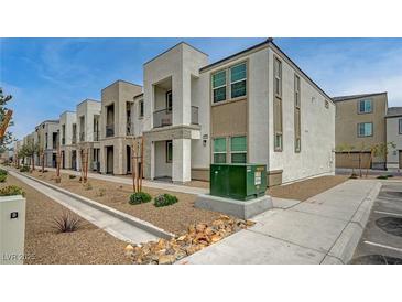 Modern townhome exteriors with stucco, stone accents, small balconies, and desert landscaping in front at 6261 Dolosonte St, Las Vegas, NV 89113