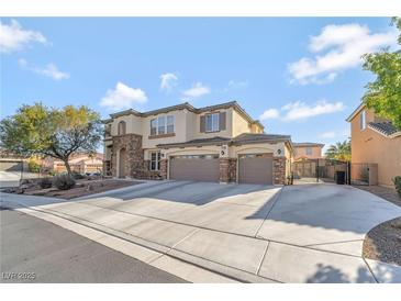 Beautiful two-story home with a three car garage, stone accents, and a spacious driveway at 7778 Villa Montara St, Las Vegas, NV 89123