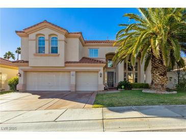 Charming two-story home with a three-car garage, mature palm tree, and well-manicured lawn at 9517 Spanish Steps Ln, Las Vegas, NV 89117