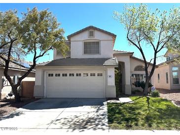 Charming two-story home featuring a well-manicured lawn and a spacious two-car garage at 981 Leadville Meadows Dr, Henderson, NV 89052