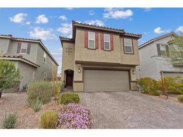 Two-story home featuring a two-car garage, neutral color palette, and well-maintained front yard at 2945 Torreon Ln, Las Vegas, NV 89121