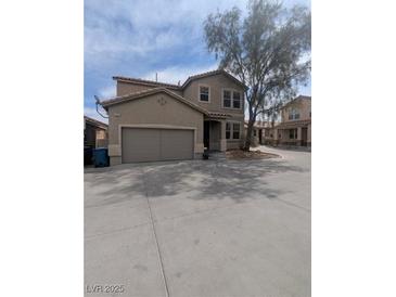 Charming two-story home featuring a two-car garage, desert landscaping, and a welcoming entrance at 529 Fork Mesa Ct, Henderson, NV 89015