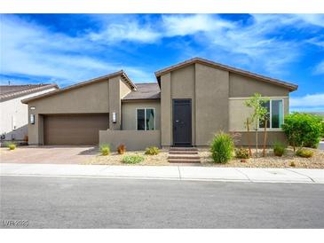 Charming single-story home featuring a desert landscaped front yard and two-car garage at 6630 Windy Palm St, North Las Vegas, NV 89086