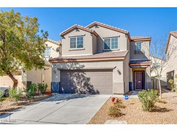 Inviting two-story home features a two-car garage and neutral-colored exterior with low-maintenance landscaping at 8173 Dusky Shadows St, Las Vegas, NV 89113