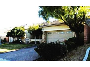 Charming single-story home featuring a two-car garage and well-manicured landscaping at 9485 Parkmoor Ave, Las Vegas, NV 89149