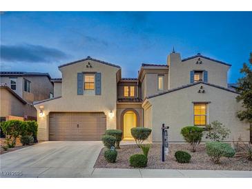Charming two-story home with a well-manicured lawn and inviting curb appeal at dusk at 1004 Bluebird Ridge Ct, North Las Vegas, NV 89084